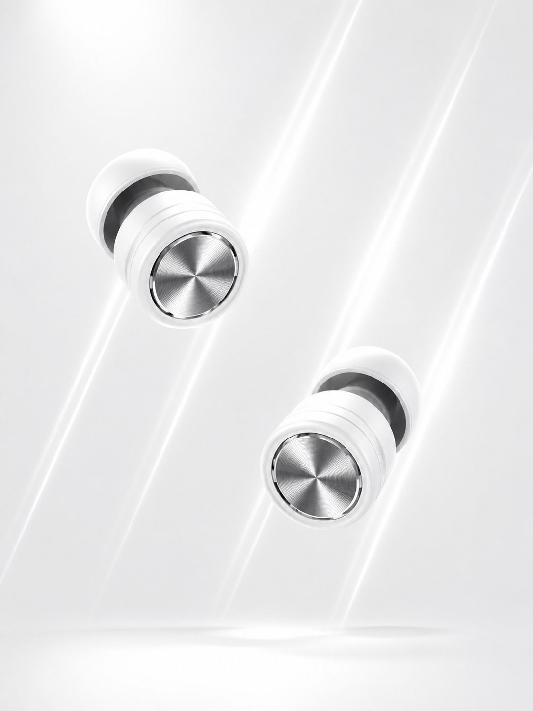 A clean product image showing a pair of black Roam Everyday™ Invisible Earplugs with brushed silver circular faceplates, floating on a soft white background with a subtle shadow.