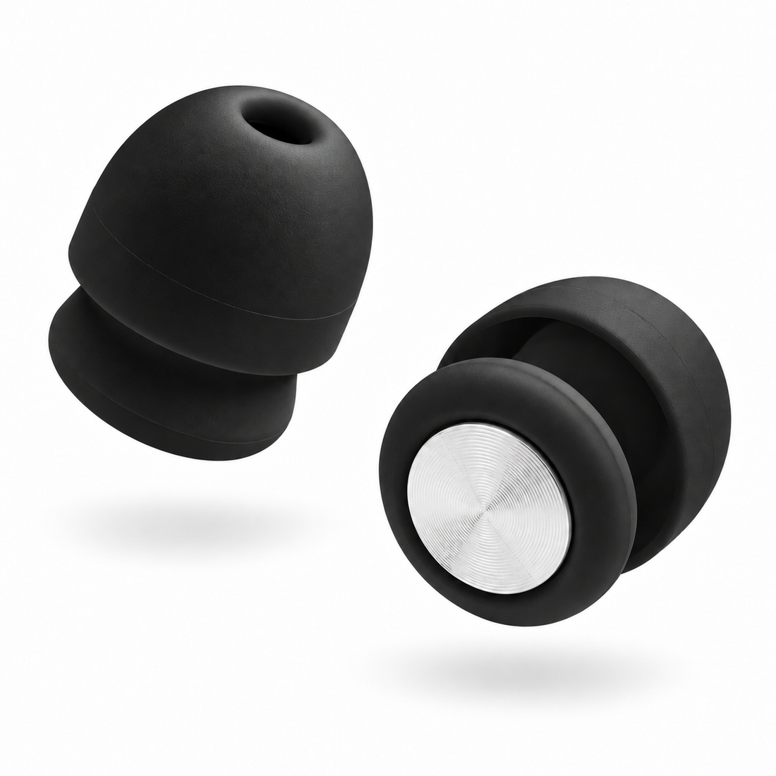 A pair of Roam Everyday Invisible Earplugs in Midnight with a silver metallic center ring, shown floating against a solid white background.