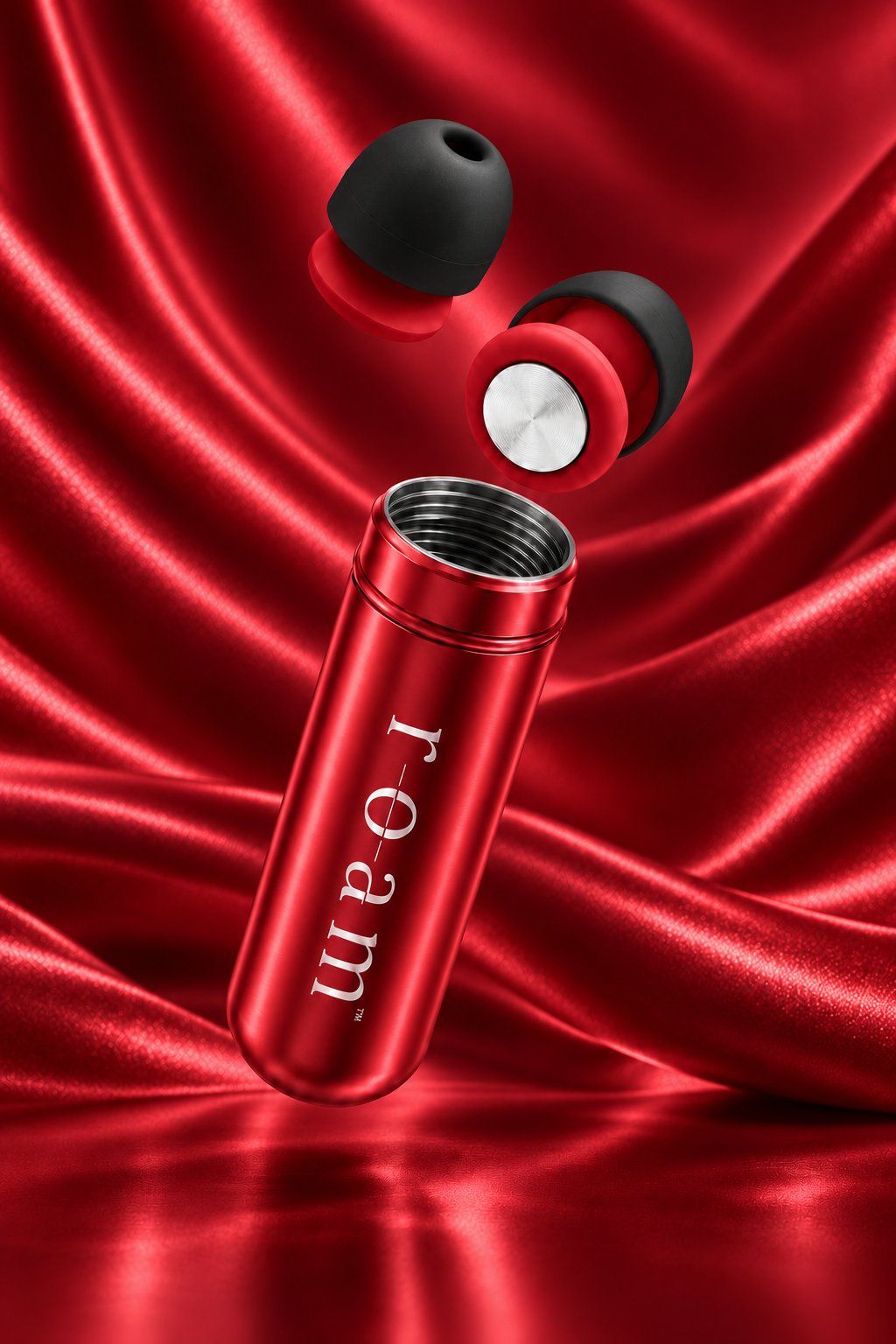 An image of Roam everyday Invisible earplugs in Crimson with matching Crimson Mini travel tube with the brand name 'roam' printed vertically in white, shown floating above two black and red earbuds against a draped red satin fabric background.