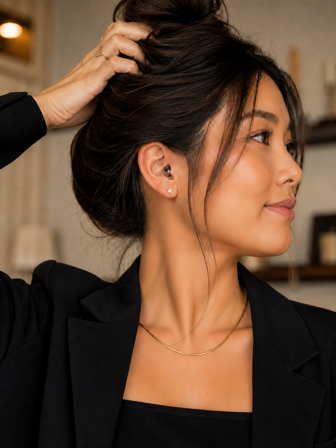 Asian woman holding her hair back with Lyve Air Earplugs in her ears 